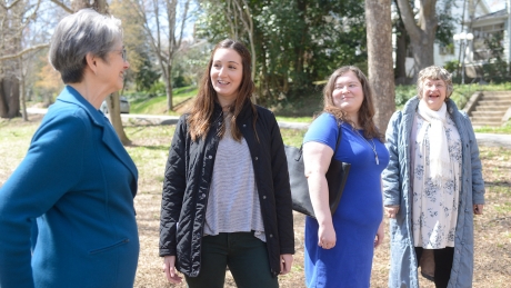 NC State social work students Laura Uribe, second from left, and Bristol Bowman, second from right, take a walk through the Cameron Park neighborhood with residents Terry Wall, far left, and Marty Lamb.