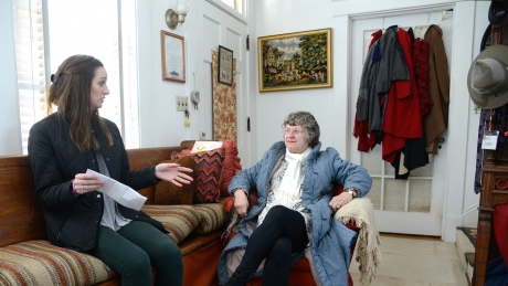 Social work student Bristol Bowman, left, discusses a neighborhood survey with Cameron Park resident Marty Lamb in Lamb’s home near downtown Raleigh. 