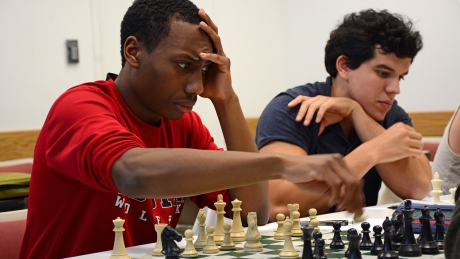 Justin Lockett moves his chess piece