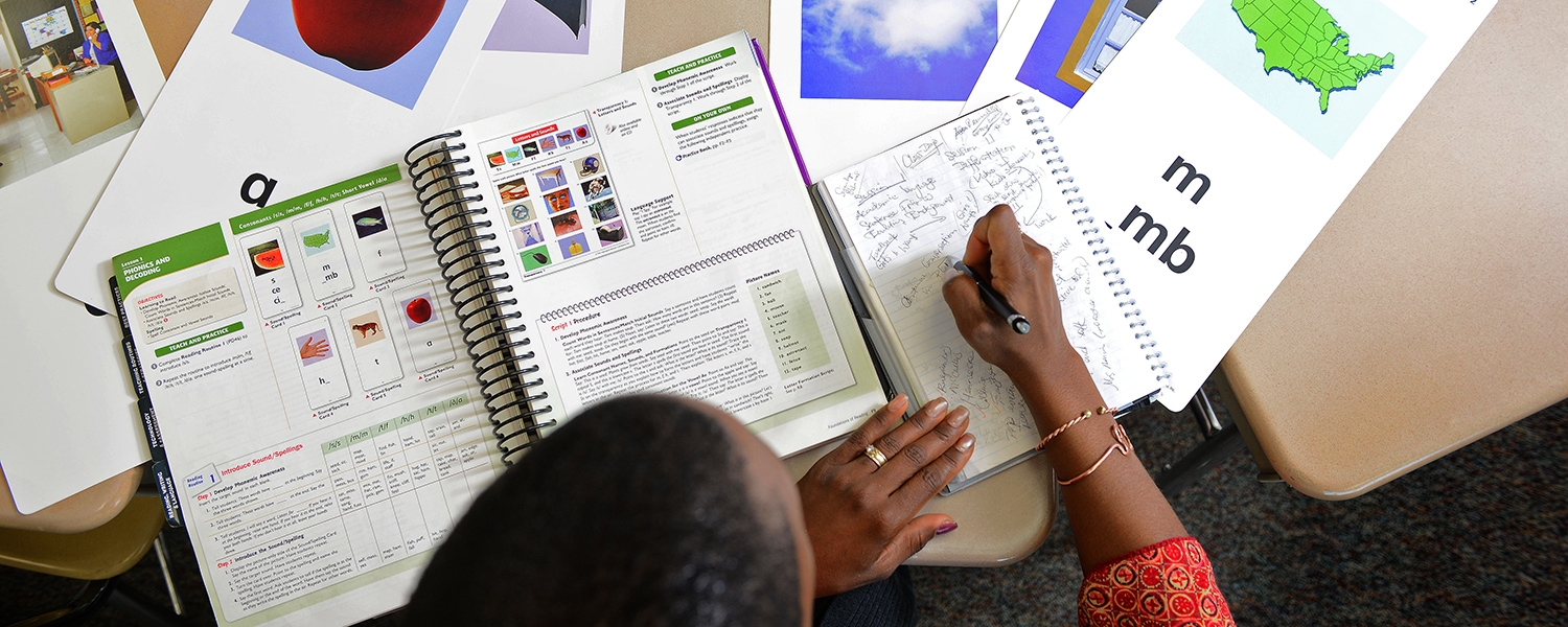 Taura Simmons takes notes at her desk