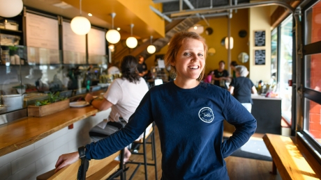 Maggie Kane stands in her restaurant, A Place at the Table