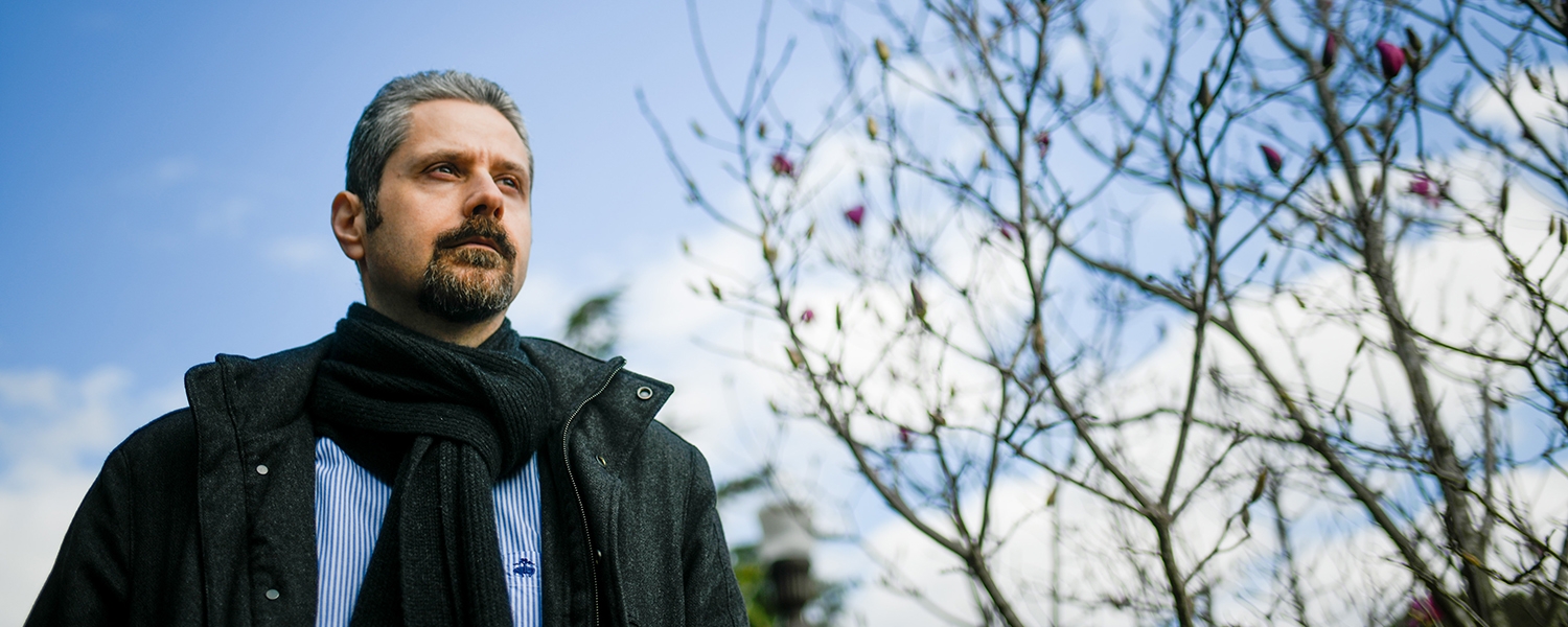 Wearing a jacket and scarf, Veljko Dubljevic looks off into the distance.