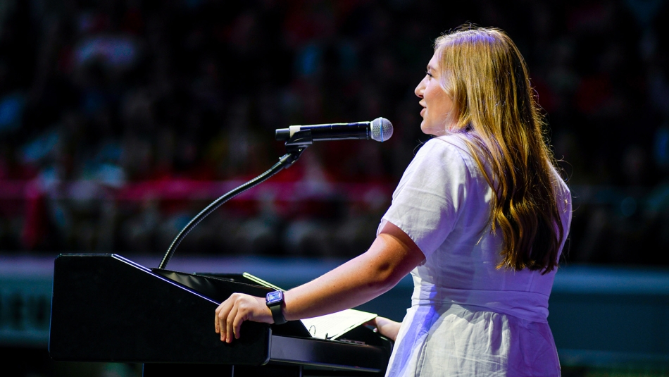 Emma Carter standing at podium