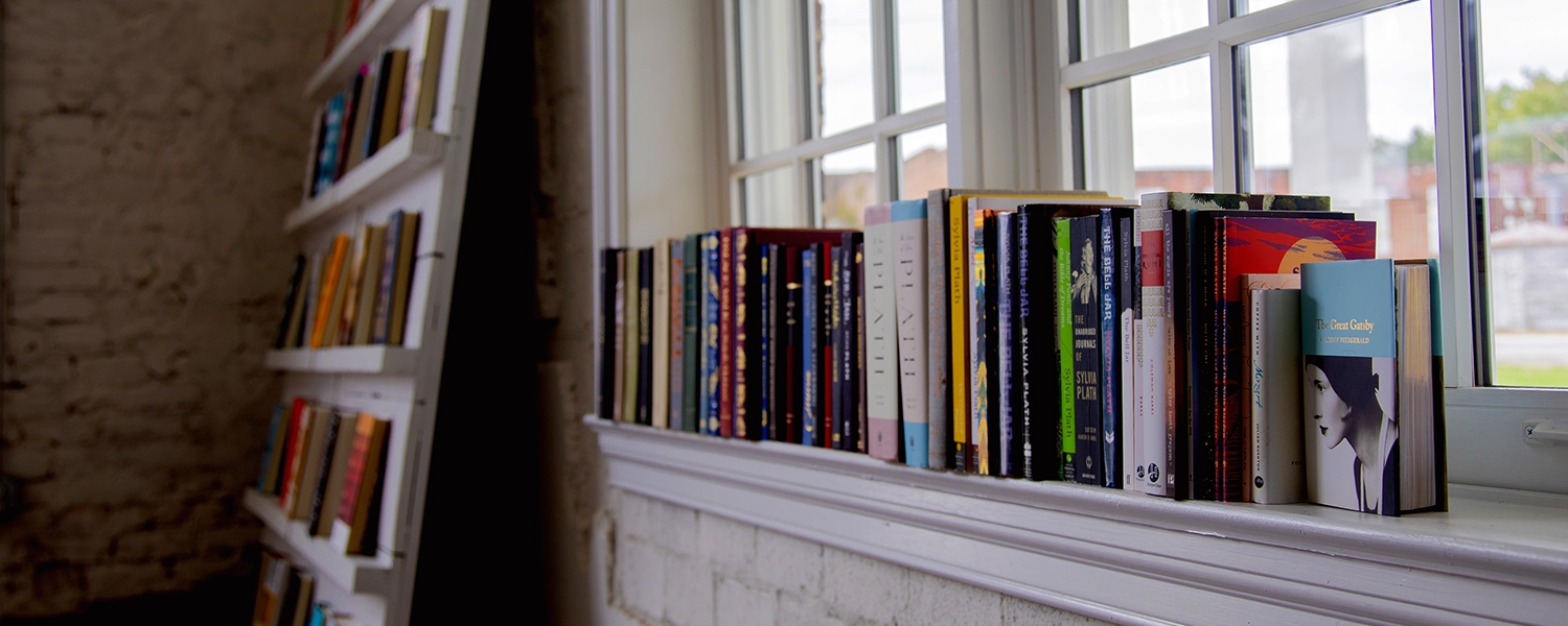 books on window sill inside Books and Beans