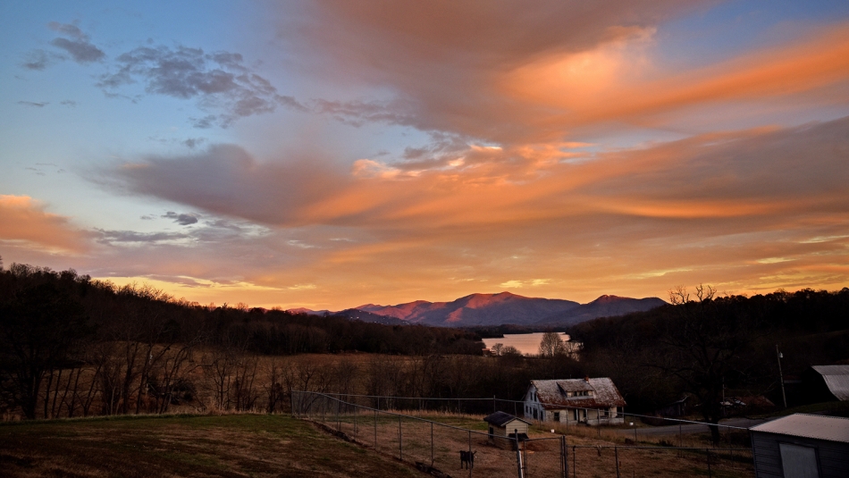 Sunset colored clouds float over Clay County’s McClure Cove