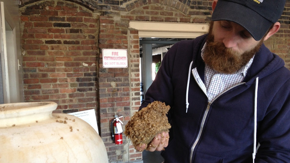 man holding ingredients for ancient beer