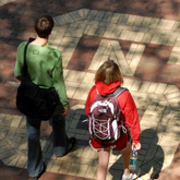 zoom to see a larger version of Students head to class on a sunny day. photo