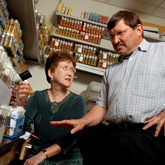 zoom to see a larger version of Trudy MacKay (left) and Robert Anholt in the lab. photo