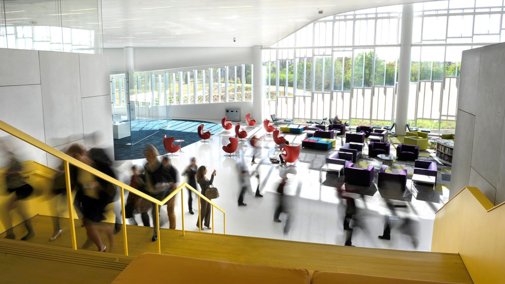 Students and faculty rush through the lobby of NC State's innovative Hunt Library