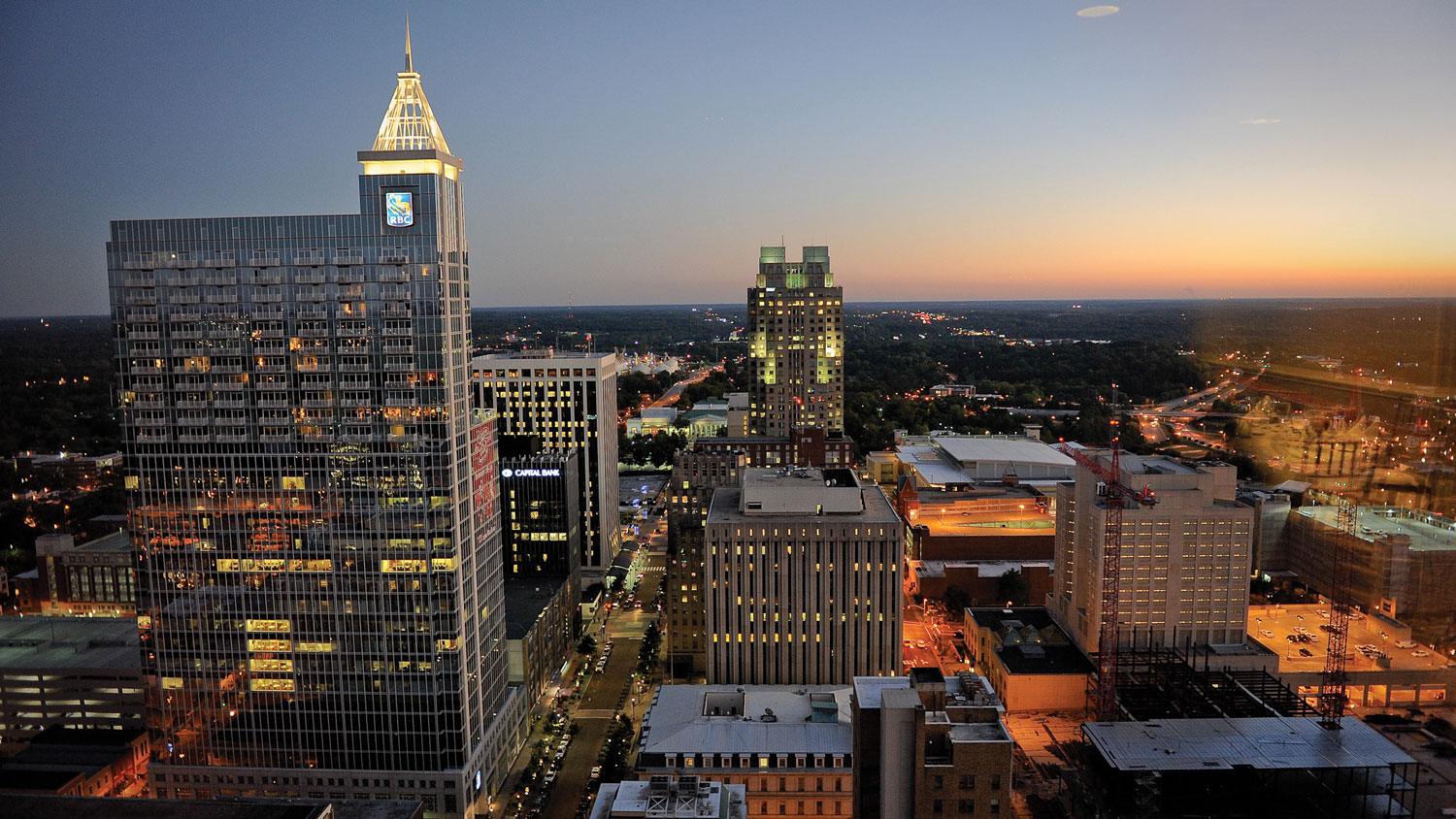 Downtown Raleigh's skyline lights up at dusk.