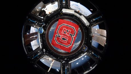 A picture from astronaut Christina Koch depicts an NC State flag on the International Space Station.