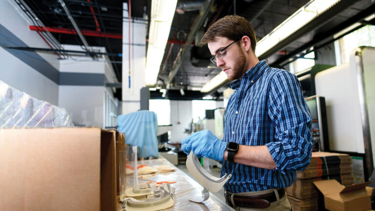 A man works to print face shields in NC State's 3D-printing lab.